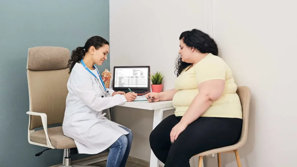 Doctor consulting an overweight woman about health and diet